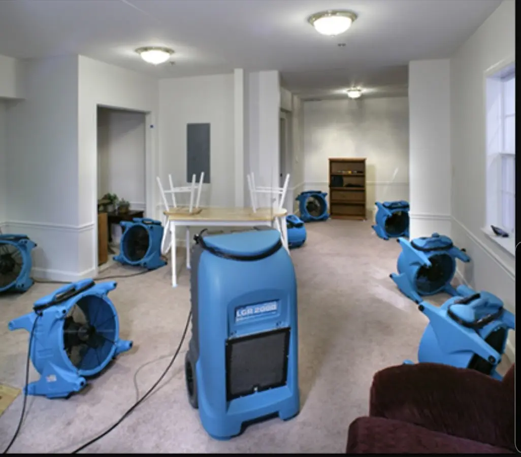 Air movers and dehumidifier setup for Water Damage Restoration in Mundy