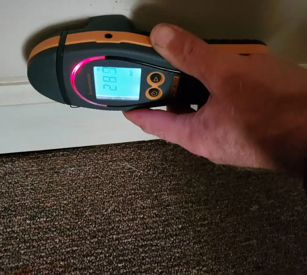Moisture detection at baseboard during Storm Damage Restoration in Mundy
